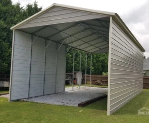 Metal carport with open sides and roof on a grassy area.