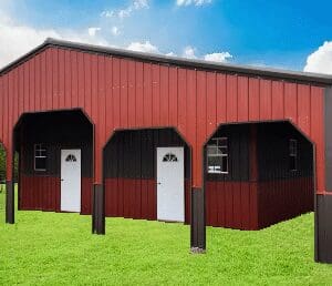 Red metal barn with white doors outside.