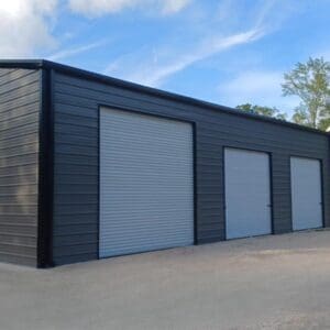 Large gray warehouse with multiple garage doors.